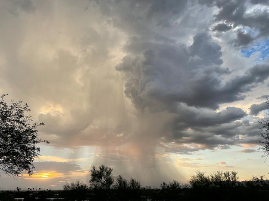 Photo of clouds and rainfall on a landscape