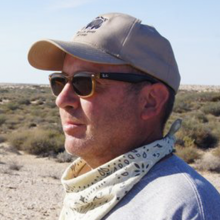 Side profile of archaeologist Jonathan Mabry in the field. 